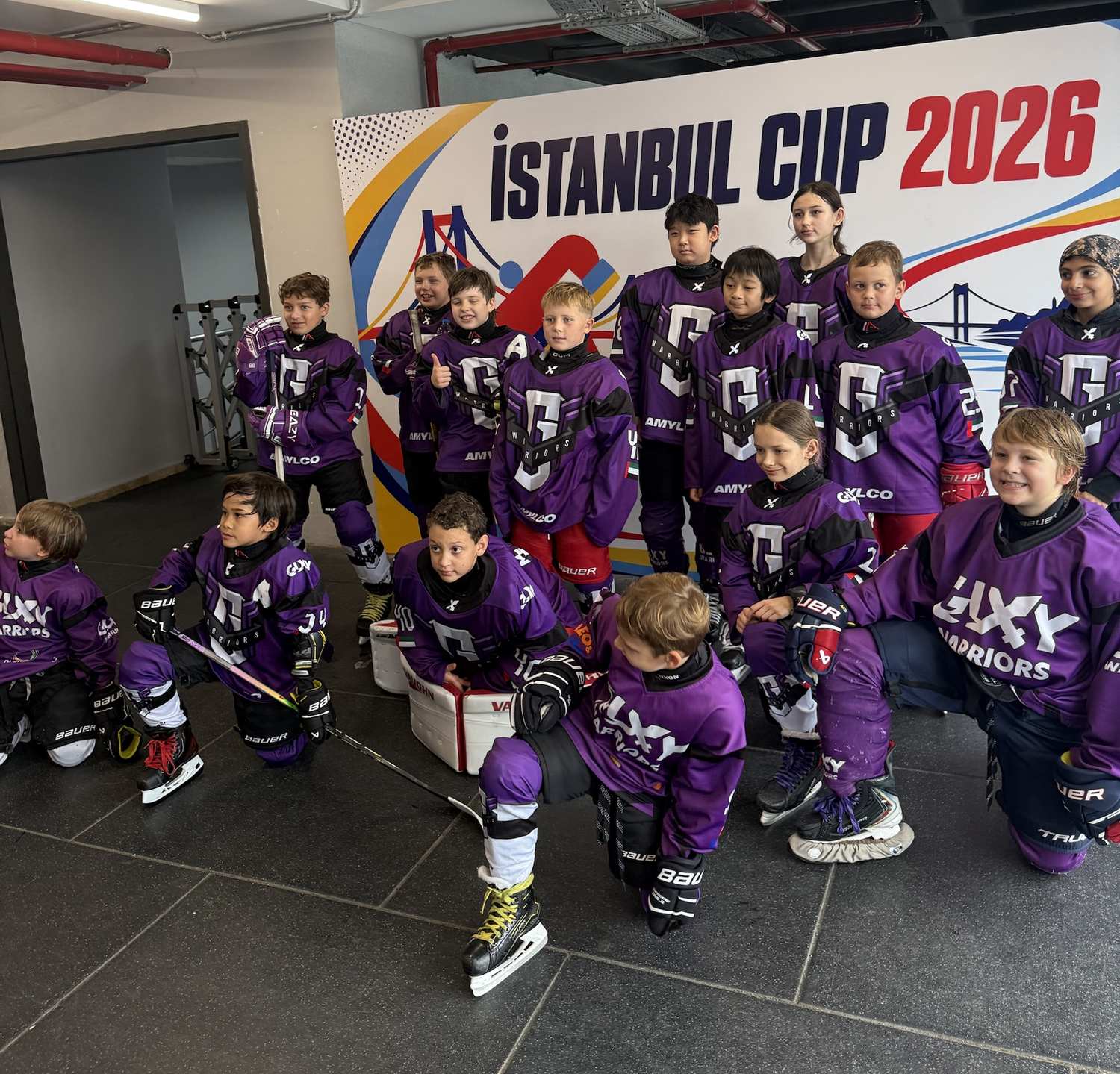 Galaxy Warriors youth team in purple jerseys in front of the Istanbul Cup 2026 banner