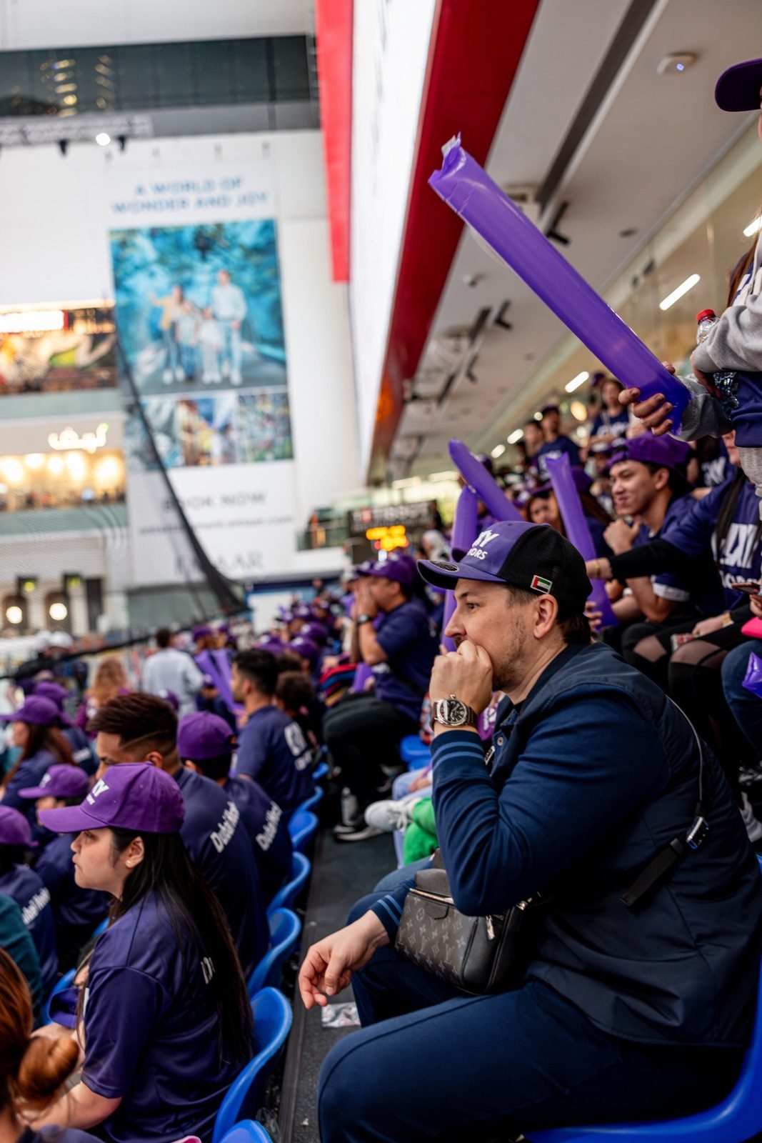 Supporters in Galaxy caps with the Dubai Mall atrium behind them